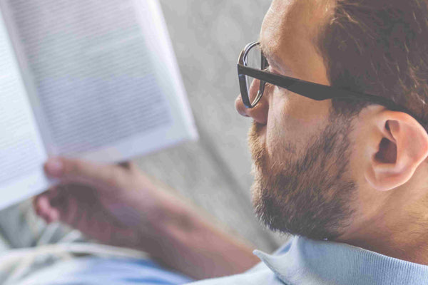 how to read faster: a man reading a book