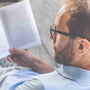 how to read faster: a man reading a book